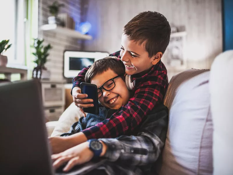 Two teenage boys on couch at home