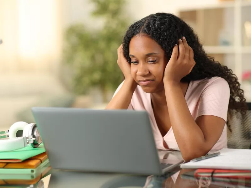 Disappointed student checking laptop