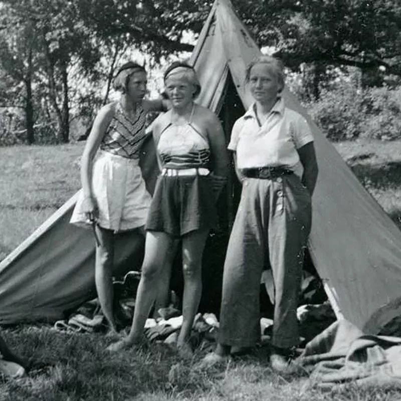 Young Woman in Trousers with Friends