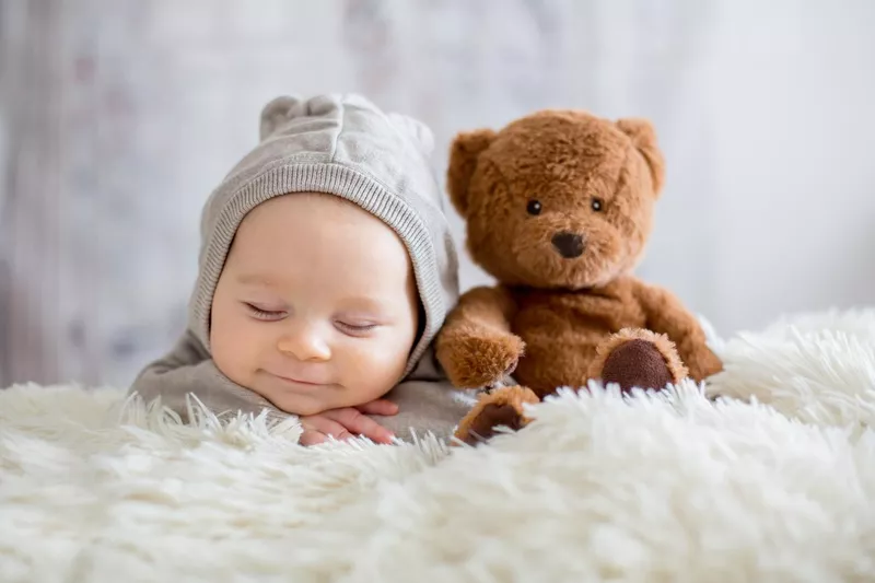 Sleeping baby smiling