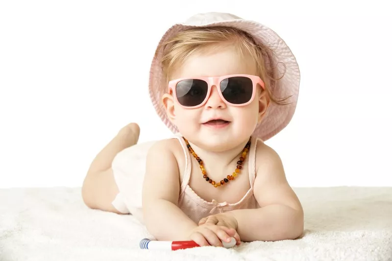 Adorable baby girl wearing pink plastic sunglasses