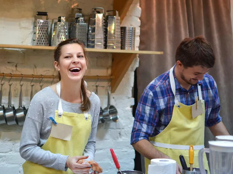 A couple cooking together in a cooking class