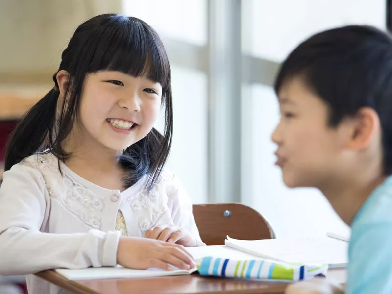 Elementary school children talking in the classroom