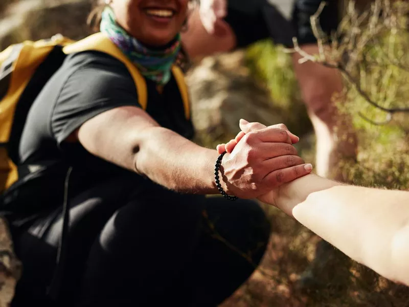 Friends reaching out to give each other a hand