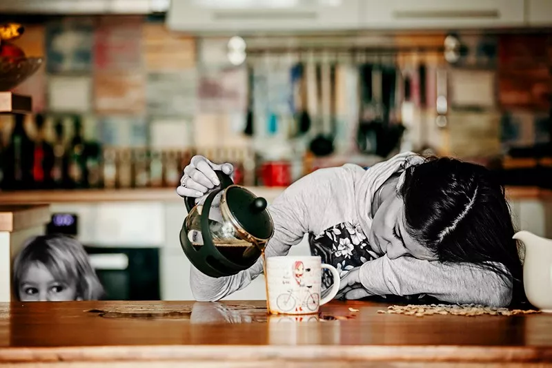 tired woman pouring coffee