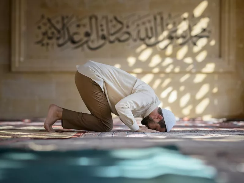 Muslim man is praying in mosque