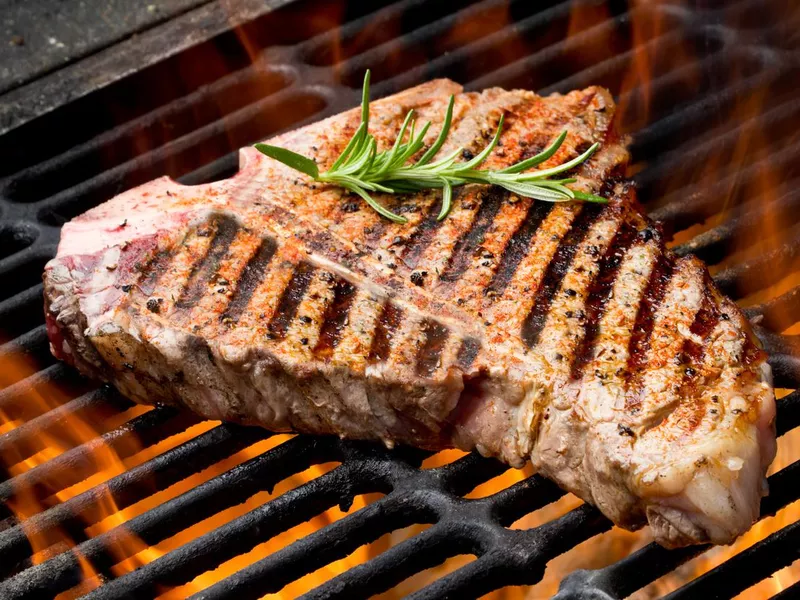 T-Bone Steak on Grill with Flames