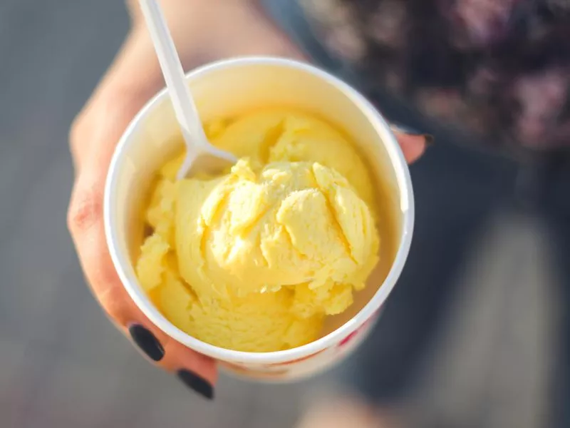 A woman's hand holds ice cream