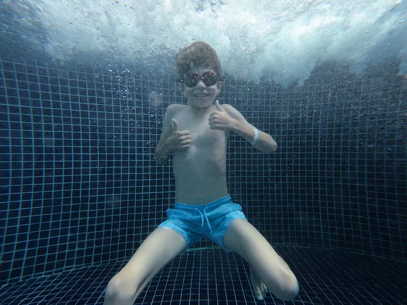 boy jumped into swimming pool