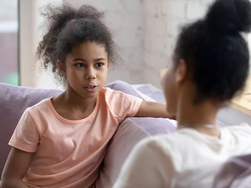 Girl talking to mother about gender fluidity