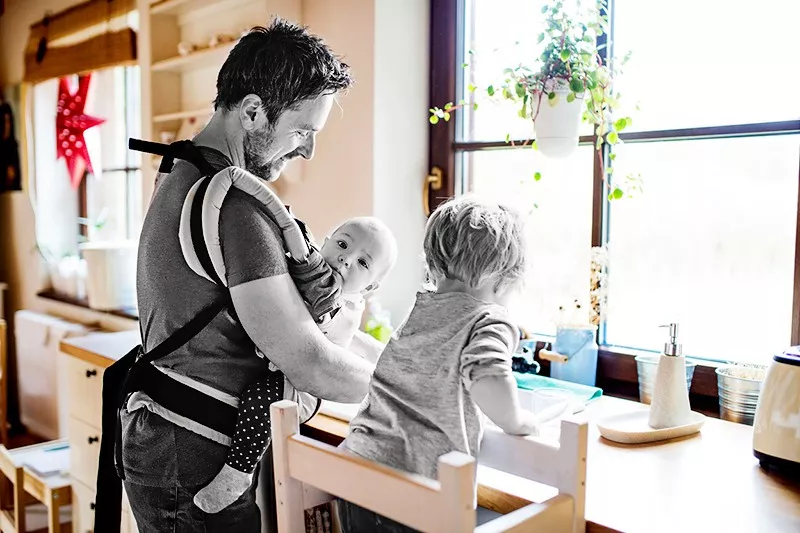 father doing chores with children