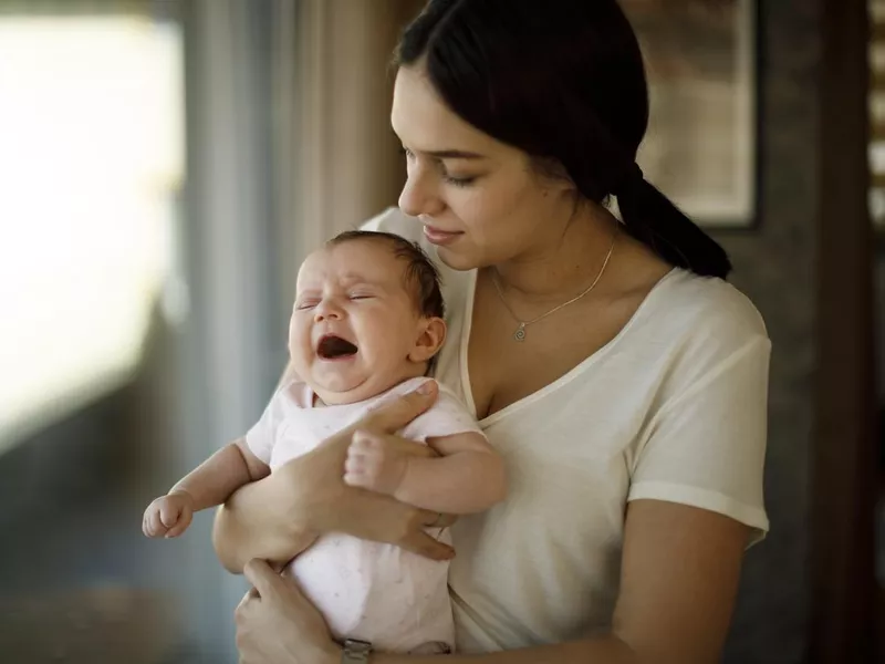 Mother taking care of a crying newborn baby