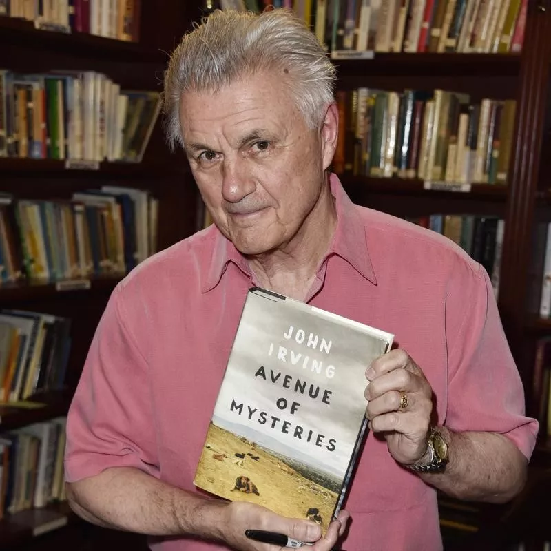 John Irving poses with book 