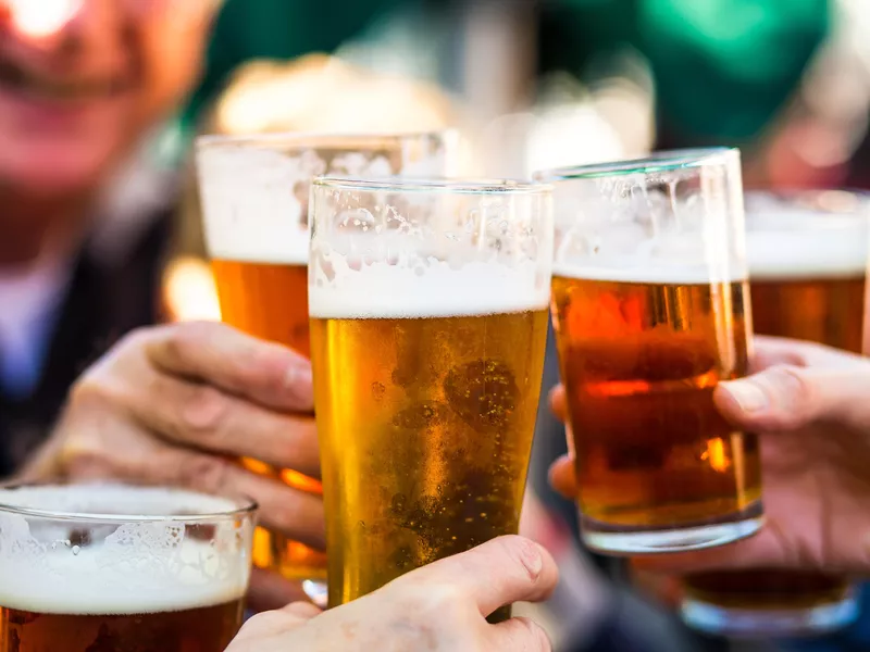 Cheers celebration toast with pints of beer