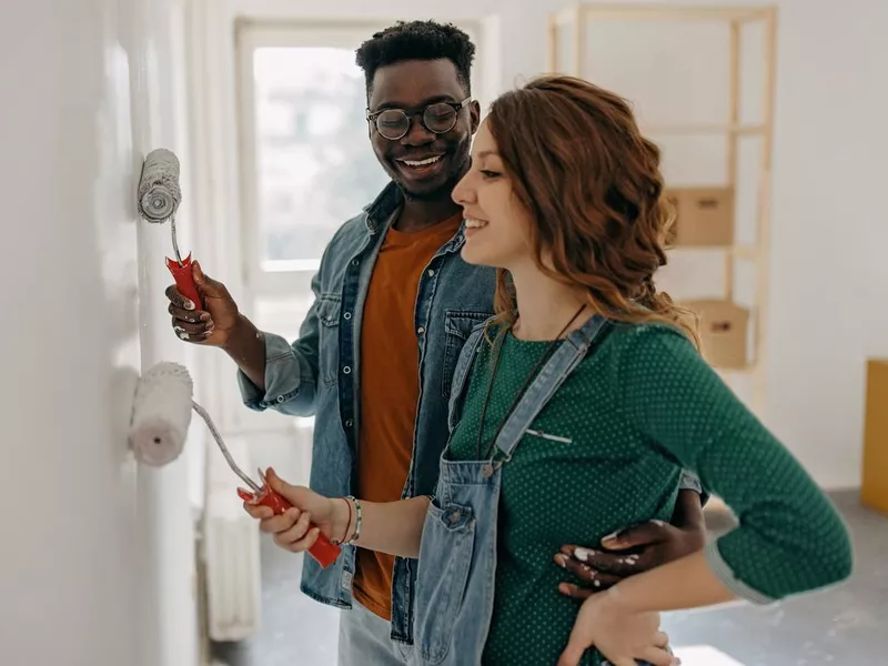 Young couple painting walls