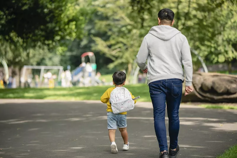 Father and daughter walking to the park