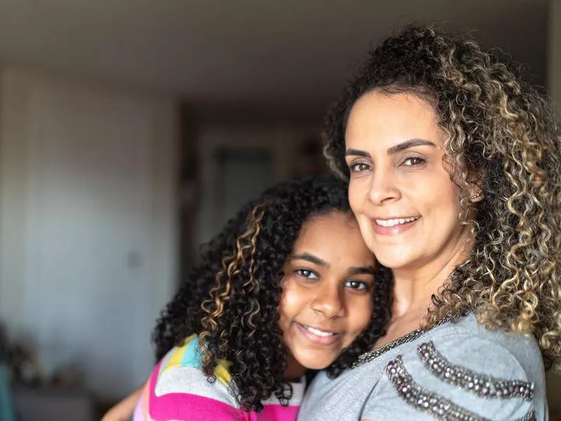 Portrait of mother and daughter embracing