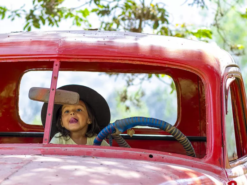 Little girl playing to drive cargo truck