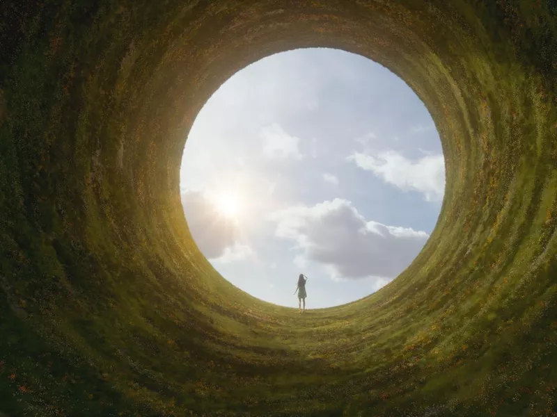 Woman standing in fantasy surreal landscape