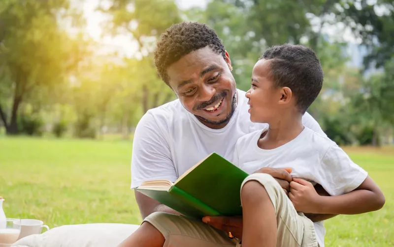 Cheerful father and son practicing sight words