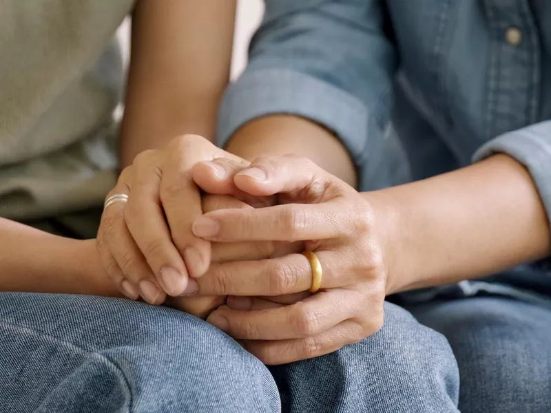 Mother and daughter holding hands