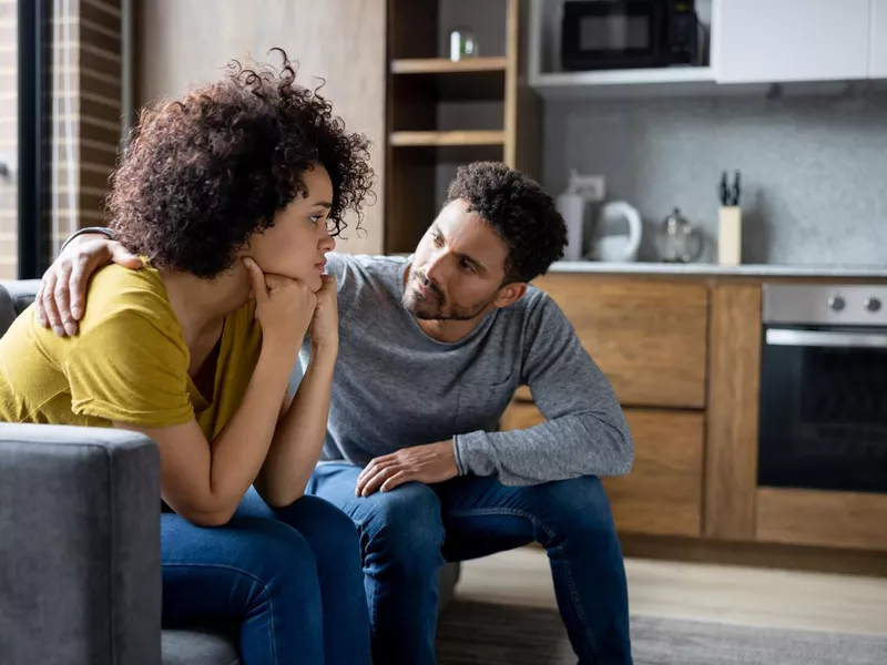 Man comforting his girlfriend at home