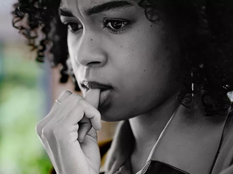 Woman biting her nails