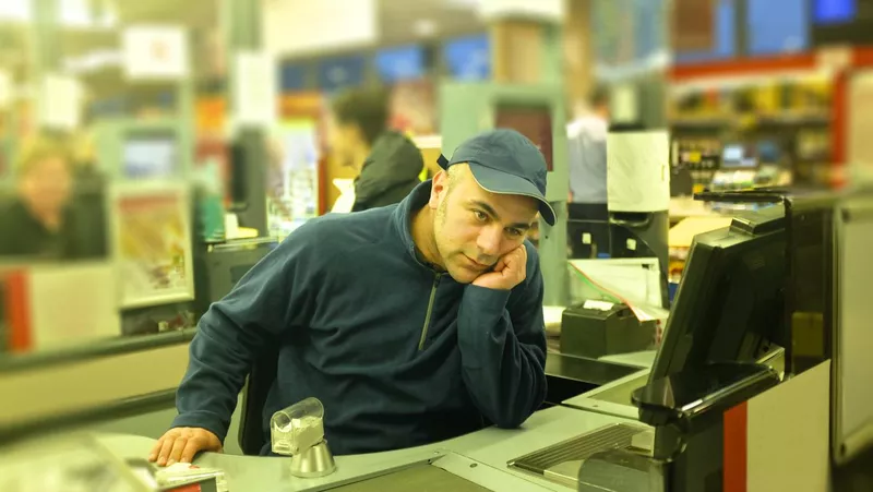 Young apprentice cashier at a supermarket