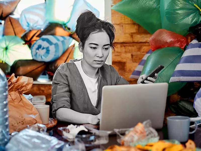 Woman at home surrounded by trash