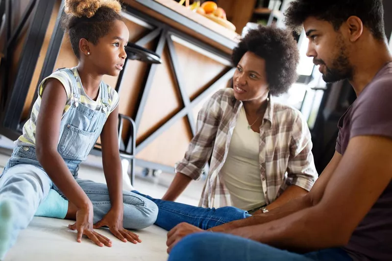 Parents having serious conversation with little girl