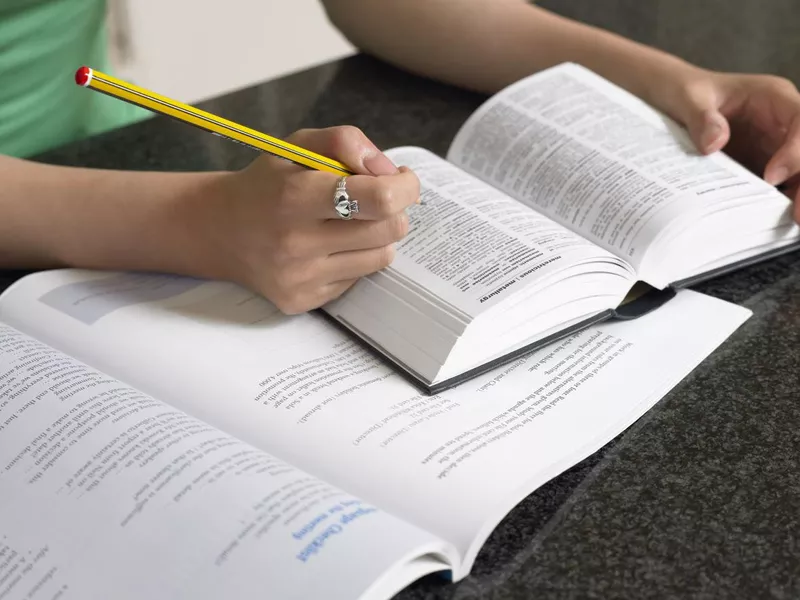 Student with dictionary and textbook