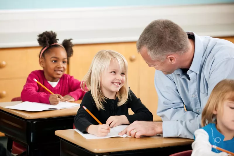 First grader smiling at teacher