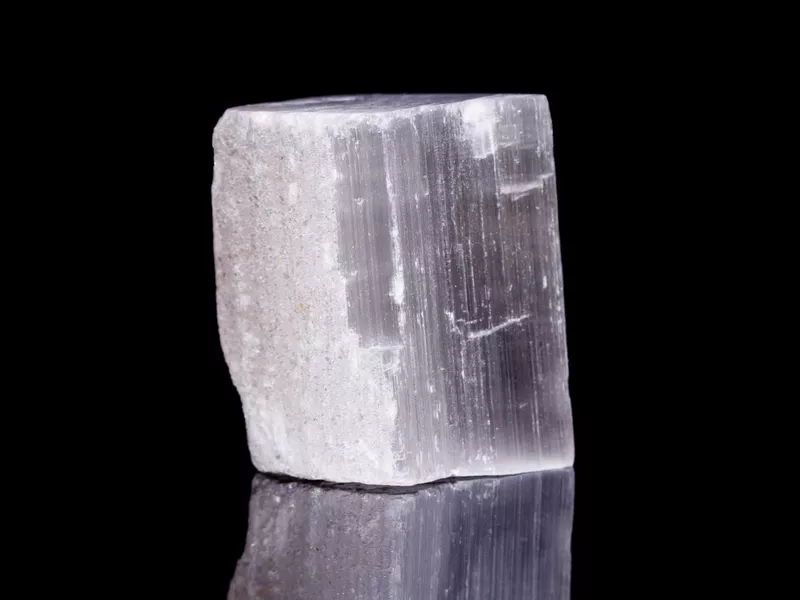 Macro mineral stone Selenite on black background