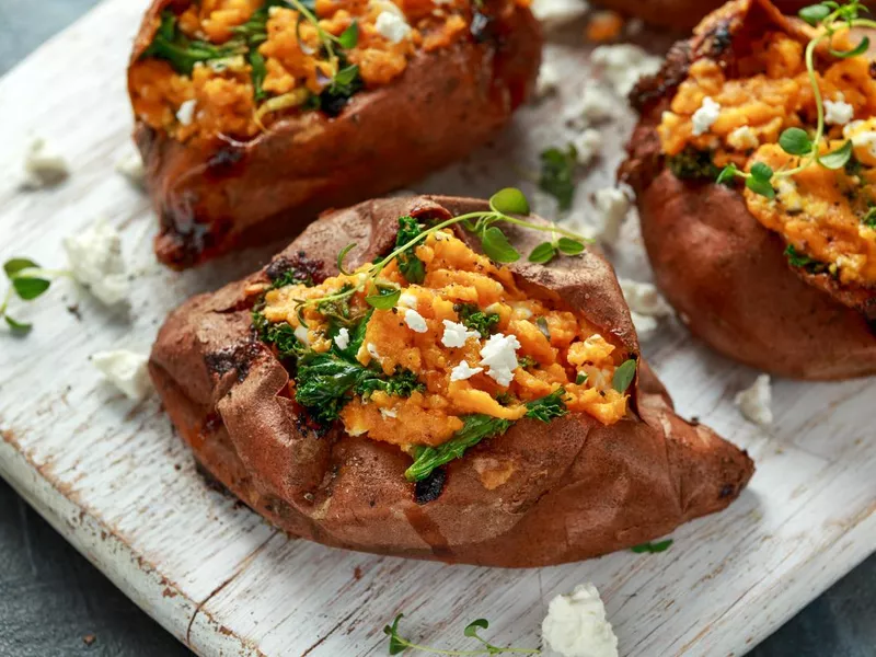 Roast sweet potato stuffed with feta cheese and kale