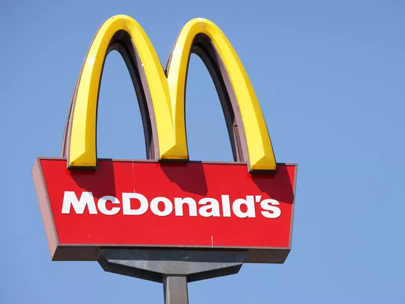 Close-up McDonalds outdoor sign against blue sky