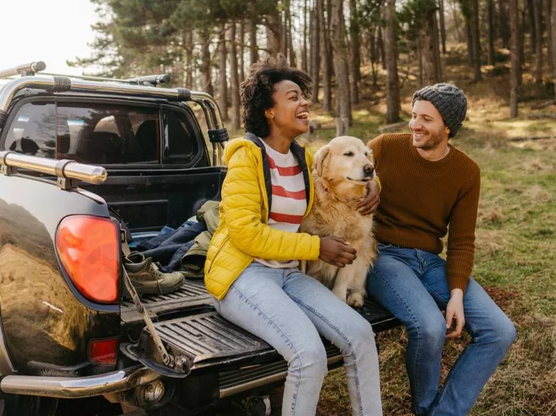 Couple on a road trip with their dog