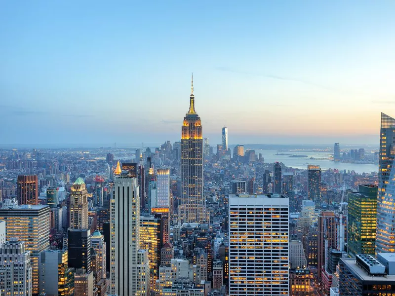 Manhattan panorama with its skyscrapers illuminated at dusk, New York