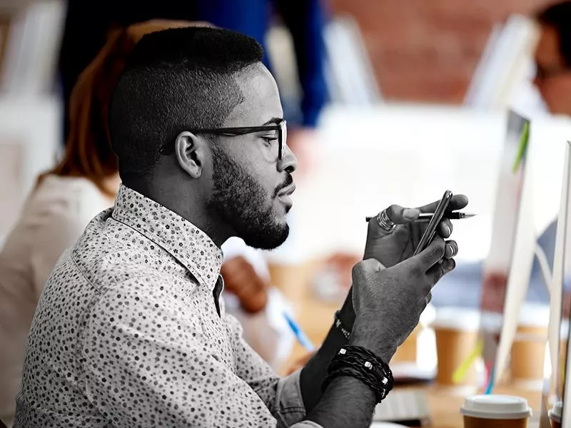 Man using smartphone at work