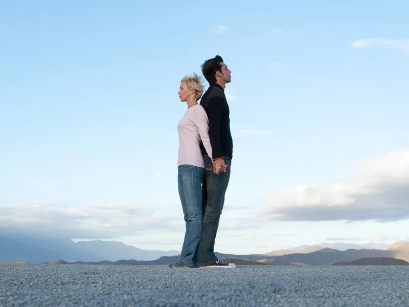 Man and woman standing back-to-back