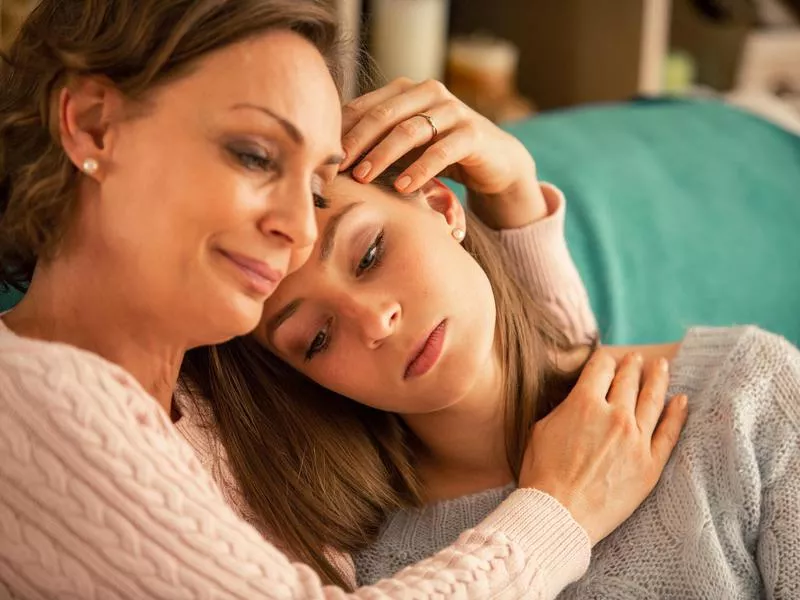 Parents consoling daughter