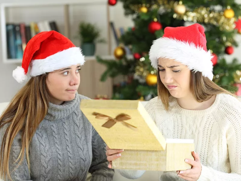 Disappointed woman receiving a gift in christmas