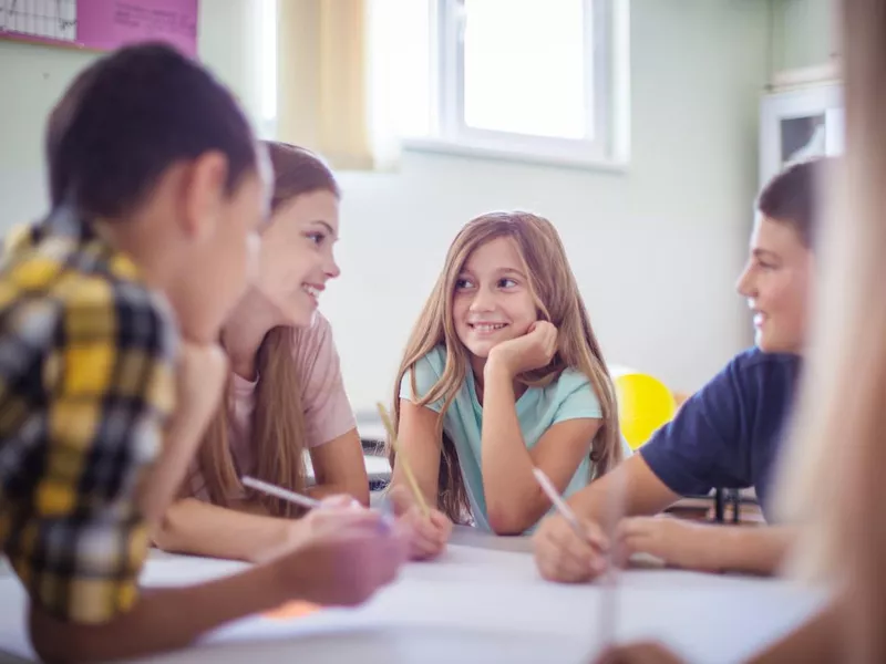 Teenagers sitting in the classroom and talking