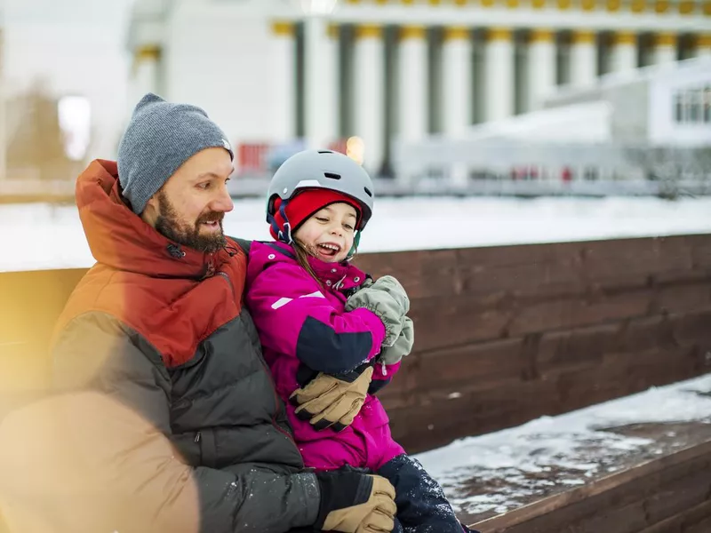 Father and daughter ice skating