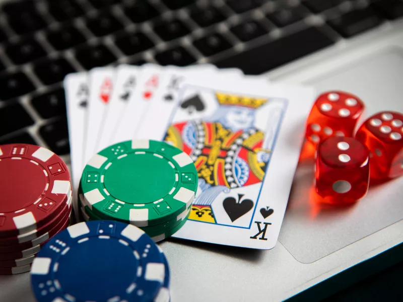 Poker chips and cards on computer keyboard