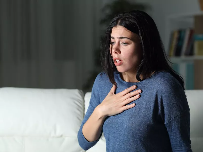 Woman suffering an anxiety attack alone in the night