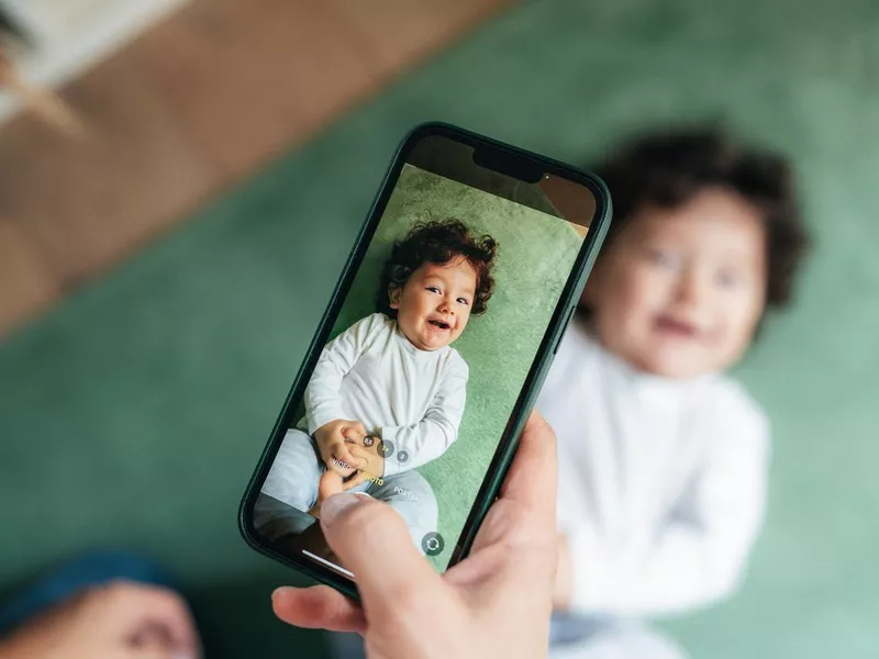 Mother taking photo of her baby