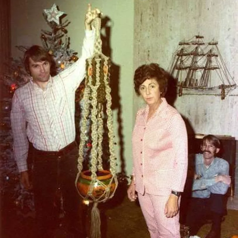 Man with hanging plant holder