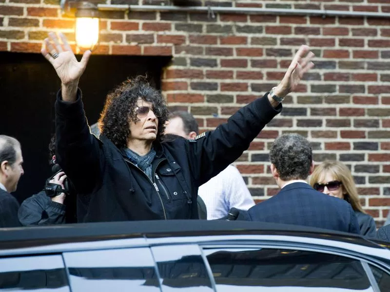 Howard Stern raises his arms