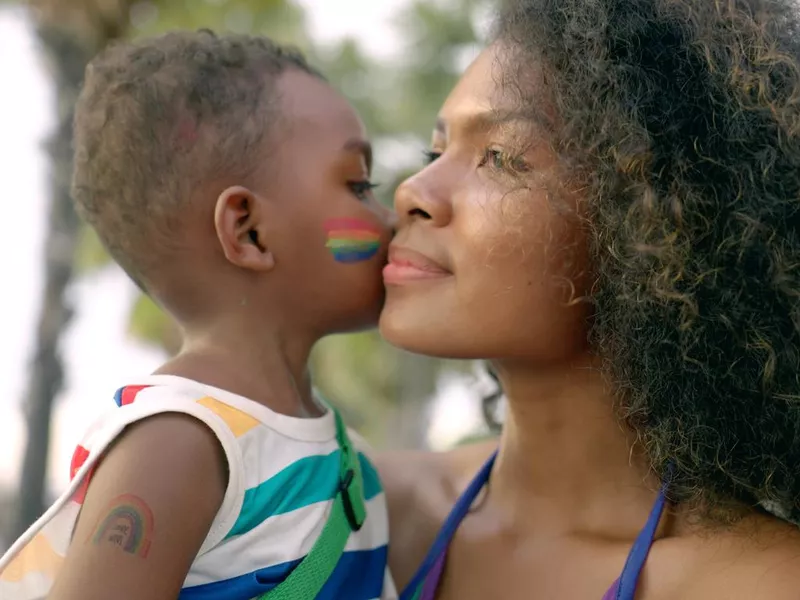 Woman and child with rainbow paint