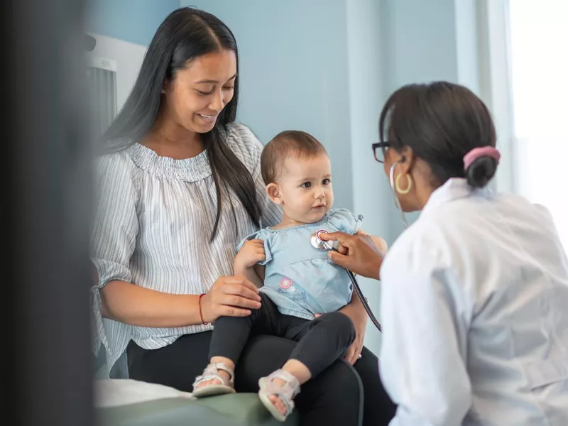 Doctor examining a baby